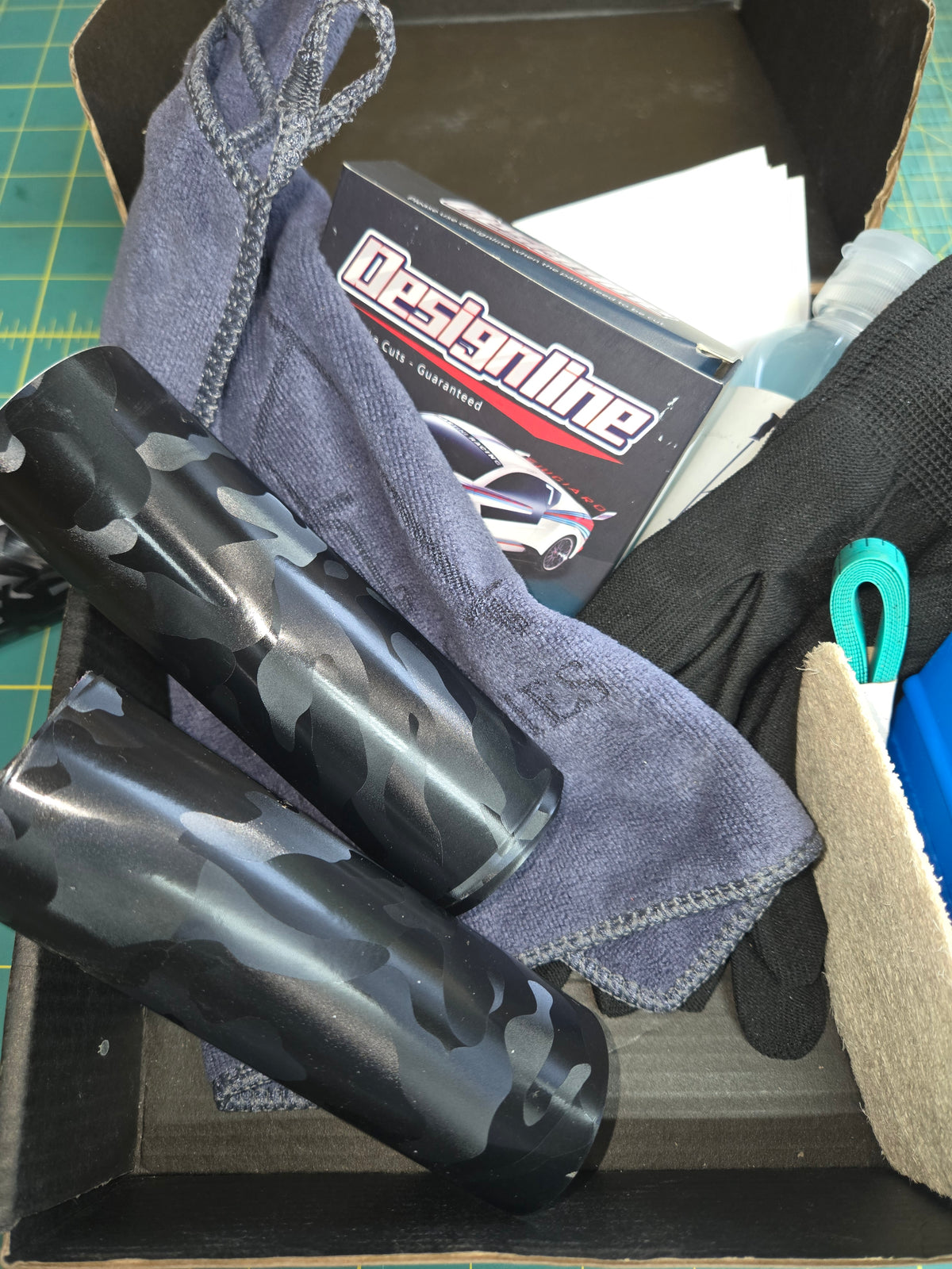 Custom ski pole wrap with matte black stealth camo pattern